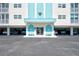 Condo building entrance with covered parking and seating at 10216 Regal Dr # 708, Largo, FL 33774