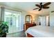Bright bedroom with wood floors and sliding glass door to balcony at 10216 Regal Dr # 708, Largo, FL 33774