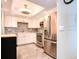 Modern kitchen featuring stainless steel appliances and white shaker cabinets at 10216 Regal Dr # 708, Largo, FL 33774