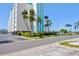 Condo building exterior with palm trees and parking at 10216 Regal Dr # 708, Largo, FL 33774