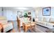 Open living space with hardwood floors, two sofas, and a view into the dining area at 10216 Regal Dr # 708, Largo, FL 33774