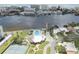 Aerial view of waterfront community pool, tennis courts, and clubhouse at 10216 Regal Dr # 708, Largo, FL 33774