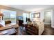 Spacious living room featuring hardwood floors, ample seating, and a view from sliding glass doors at 10216 Regal Dr # 708, Largo, FL 33774