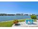 Relaxing waterfront view with bench and lush landscaping at 10216 Regal Dr # 708, Largo, FL 33774