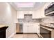 Updated kitchen with stainless steel appliances and white cabinets at 10216 Regal Dr # 708, Largo, FL 33774