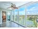 Sunroom with tiled floors, ceiling fan, and stunning views from sliding glass doors at 10216 Regal Dr # 708, Largo, FL 33774