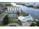 Aerial view of condo building, pool, and tennis courts at 10216 Regal Dr # 708, Largo, FL 33774