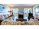Living area with hardwood floors, comfortable seating and large windows offering an outdoor view at 10216 Regal Dr # 708, Largo, FL 33774