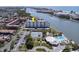 Aerial view of building, pool, tennis courts, and waterfront at 10216 Regal Dr # 708, Largo, FL 33774