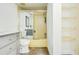 Bathroom with yellow tiled shower and gray vanity at 10216 Regal Dr # 708, Largo, FL 33774