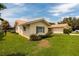Single story home with orange tile roof and green shutters at 1985 Michigan Ne Ave, St Petersburg, FL 33703
