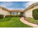 House entrance with green shrubs and a curved walkway at 1985 Michigan Ne Ave, St Petersburg, FL 33703