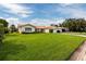 Single-story house with a large green lawn and a white garage door at 1985 Michigan Ne Ave, St Petersburg, FL 33703