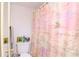 Bathroom featuring shower with a patterned shower curtain at 2400 Winding Creek Blvd # 25-101, Clearwater, FL 33761