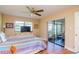 Main bedroom features laminate wood floors, ceiling fan, and screened porch access at 2400 Winding Creek Blvd # 25-101, Clearwater, FL 33761