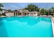 Community pool with lounge chairs at 2400 Winding Creek Blvd # 25-101, Clearwater, FL 33761
