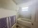 Renovation project: A bathroom in progress with a tub, shower, and exposed walls at 4411 Rustic Dr # 4411, New Port Richey, FL 34652