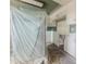 Image of kitchen during renovation with white cabinetry and new appliances covered in plastic at 4411 Rustic Dr # 4411, New Port Richey, FL 34652