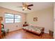 Bright bedroom featuring a futon and hardwood floors at 2400 Winding Creek Blvd # 25-101, Clearwater, FL 33761