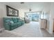 Bright living room featuring a teal couch, recliner, and view into additional living space at 4411 Rustic Dr # 4411, New Port Richey, FL 34652