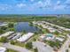 Aerial view showcasing community, pool, and lake at 4411 Rustic Dr # 4411, New Port Richey, FL 34652