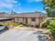 Exterior view of condo unit with carport and landscaping at 4411 Rustic Dr # 4411, New Port Richey, FL 34652