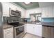 Modern kitchen with stainless steel appliances and white cabinets at 4411 Rustic Dr # 4411, New Port Richey, FL 34652