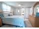 Main bedroom with a king-size bed, dresser, and access to the bathroom at 4411 Rustic Dr # 4411, New Port Richey, FL 34652