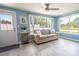 Living room with a comfy couch, large windows, and access to backyard at 4411 Rustic Dr # 4411, New Port Richey, FL 34652
