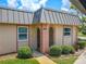 Condo unit's front entrance with landscaping at 4411 Rustic Dr # 4411, New Port Richey, FL 34652