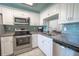 Modern kitchen with stainless steel appliances and white cabinets at 4411 Rustic Dr # 4411, New Port Richey, FL 34652