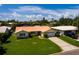 House with orange tile roof, two-car garage, and lush lawn at 1985 Michigan Ne Ave, St Petersburg, FL 33703