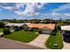 Single-story house with a tile roof, large yard and driveway at 1985 Michigan Ne Ave, St Petersburg, FL 33703