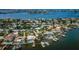 Aerial showing waterfront homes, boats, and docks at 6944 S Shore S Dr, South Pasadena, FL 33707