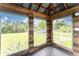 Relaxing screened porch with wooden walls and view of the backyard at 10517 Greenway Ave, Englewood, FL 34224