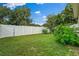 A spacious, green backyard with a white fence surrounding the perimeter at 1740 51St N St, St Petersburg, FL 33710