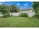 Expansive backyard featuring lush green grass, a white fence, and mature trees at 1740 51St N St, St Petersburg, FL 33710