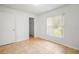 Well-lit bedroom with neutral colors, a large window with blinds, and tile flooring, creating a clean and airy space at 1740 51St N St, St Petersburg, FL 33710