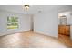 Clean and simple bedroom with ceramic tile flooring, a window, and access to the bathroom at 1740 51St N St, St Petersburg, FL 33710
