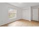 Bedroom featuring tile flooring, bright window with blinds, and a closet at 1740 51St N St, St Petersburg, FL 33710