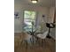 Cozy dining area with modern table, chairs, and a view of the lush outdoors at 1740 51St N St, St Petersburg, FL 33710