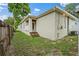 Exterior side view of a home with a backyard entrance and three wooden steps at 1740 51St N St, St Petersburg, FL 33710