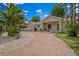 Charming single-story home featuring a beautiful brick driveway and lush tropical landscaping at 1740 51St N St, St Petersburg, FL 33710