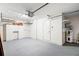 Spacious garage offering ample storage, featuring built-in cabinets, shelving, and a clean, painted floor for functionality at 1740 51St N St, St Petersburg, FL 33710