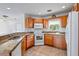 Well-equipped kitchen featuring granite countertops, wooden cabinets, and stainless steel appliances at 1740 51St N St, St Petersburg, FL 33710