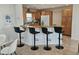 Open kitchen area featuring a breakfast bar, modern stools, and ample countertop space at 1740 51St N St, St Petersburg, FL 33710