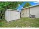 Backyard with a storage shed and the side of the house with utilities attached at 1740 51St N St, St Petersburg, FL 33710