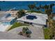 Waterfront property with solar panels, a spacious driveway, and a view of the bay and boats at 4751 Baywood Point S Dr, Gulfport, FL 33711