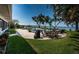 Backyard space with brick paver patio, outdoor table, grill, and view of the bay at 4751 Baywood Point S Dr, Gulfport, FL 33711