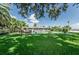 Large backyard featuring a pool and patio area with outdoor seating, perfect for relaxation at 4751 Baywood Point S Dr, Gulfport, FL 33711